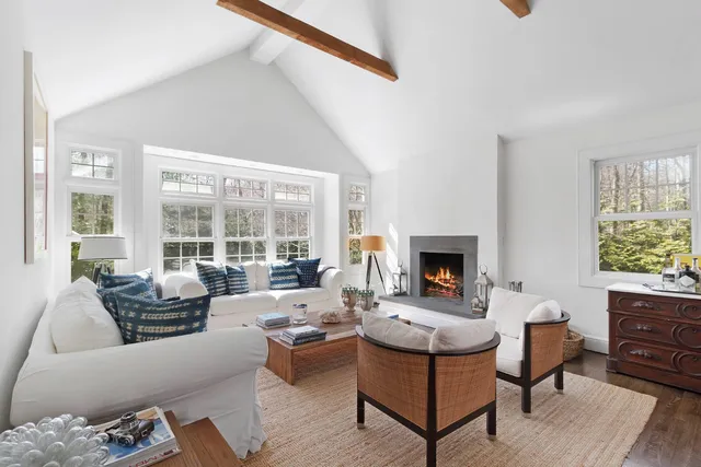 a living room with furniture large window and a fireplace