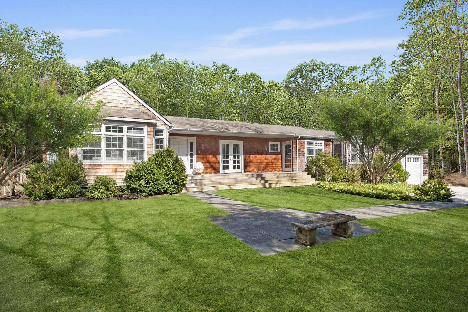 334 Brick Kiln Road Sag Harbor, NY 11963 - Photo 18 of 18 a front view of a house with a yard and trees