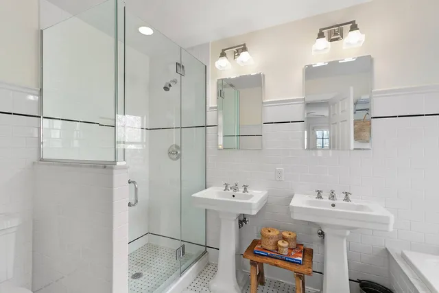 a bathroom with a sink mirror and a shower