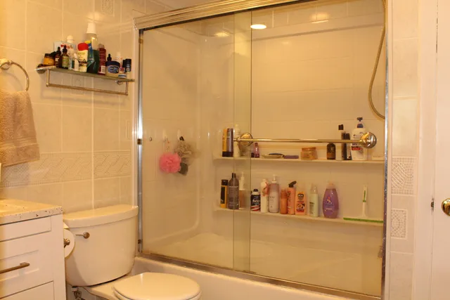 a bathroom with a sink mirror vanity and toilet