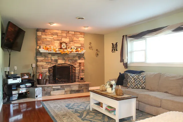 a living room with furniture a flat screen tv and a fireplace