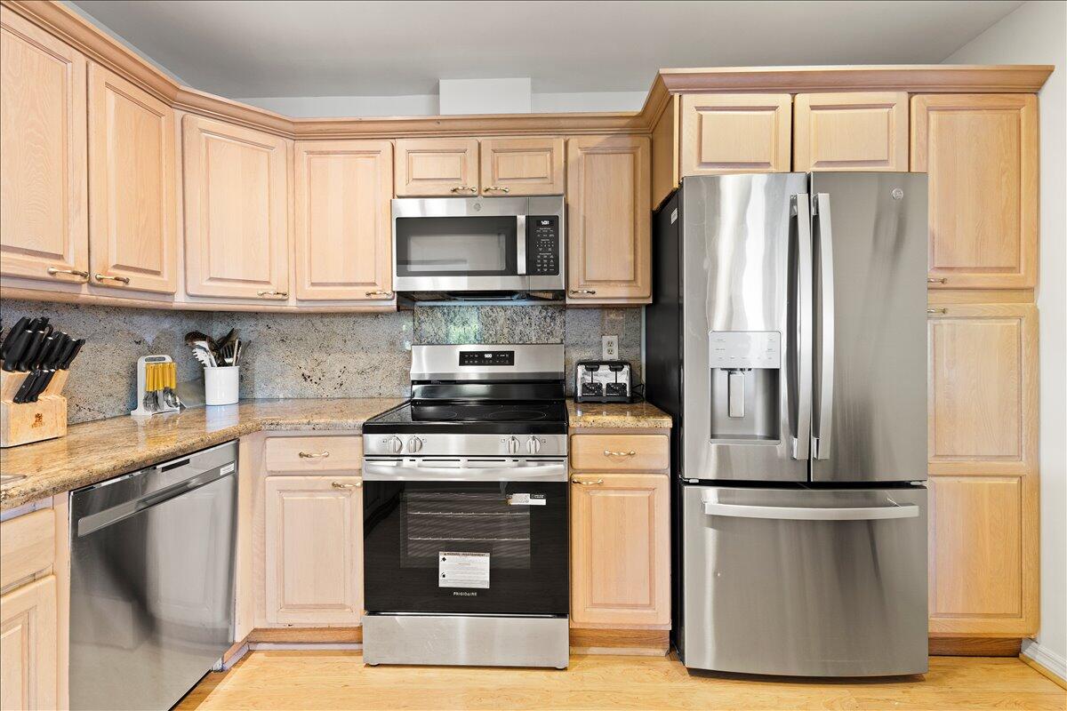 233 Rio Vista Circle Atlantis, FL 33462 - Photo 15 of 38 a kitchen with kitchen island granite countertop a stove top oven a refrigerator and a sink