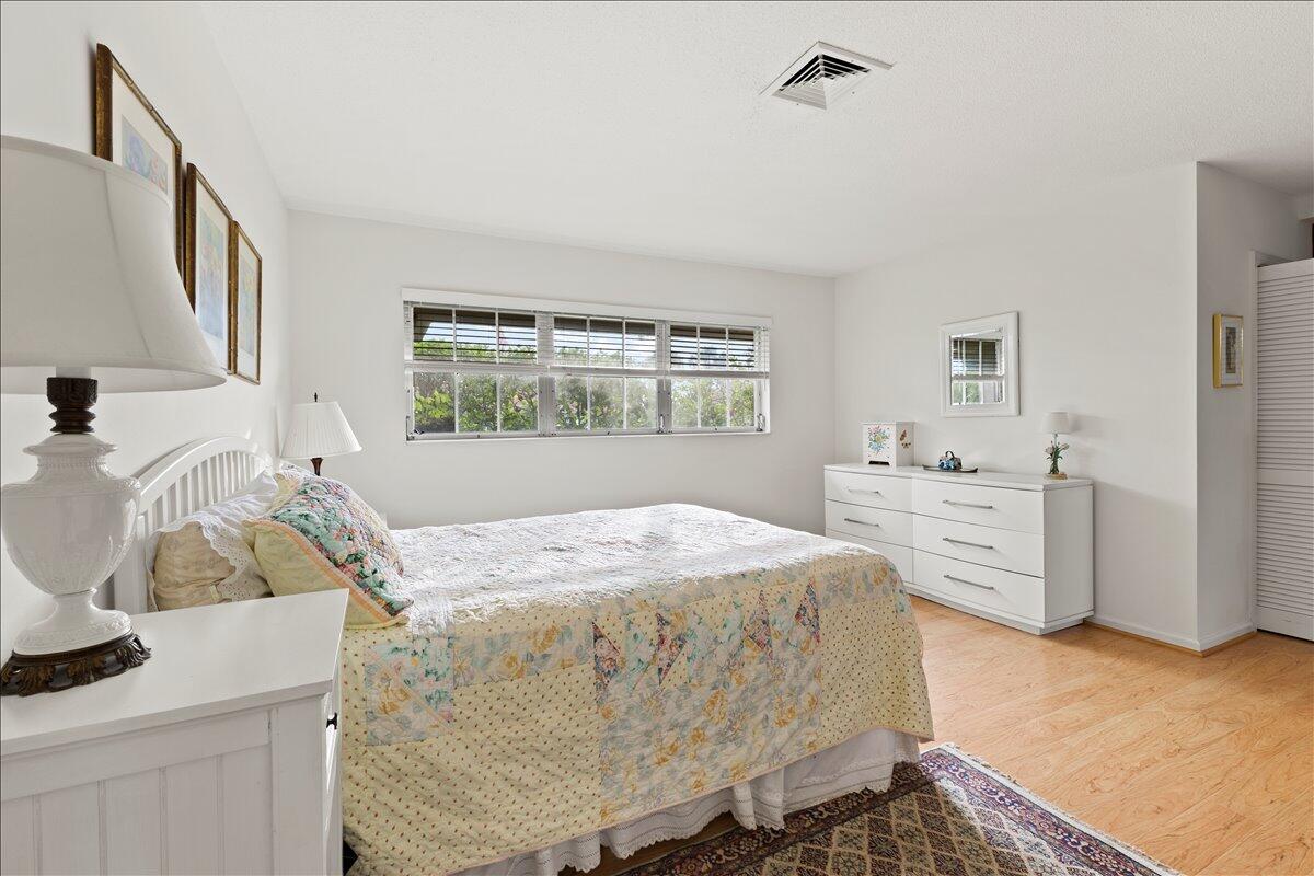 233 Rio Vista Circle Atlantis, FL 33462 - Photo 19 of 38 a bed room with a bed and a dresser