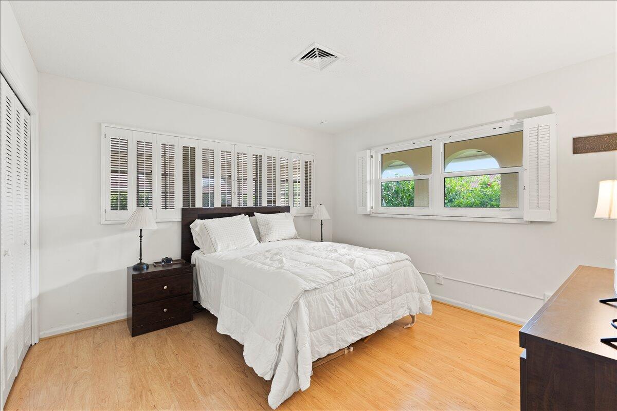 233 Rio Vista Circle Atlantis, FL 33462 - Photo 22 of 38 a bed sitting in a bedroom next to a window