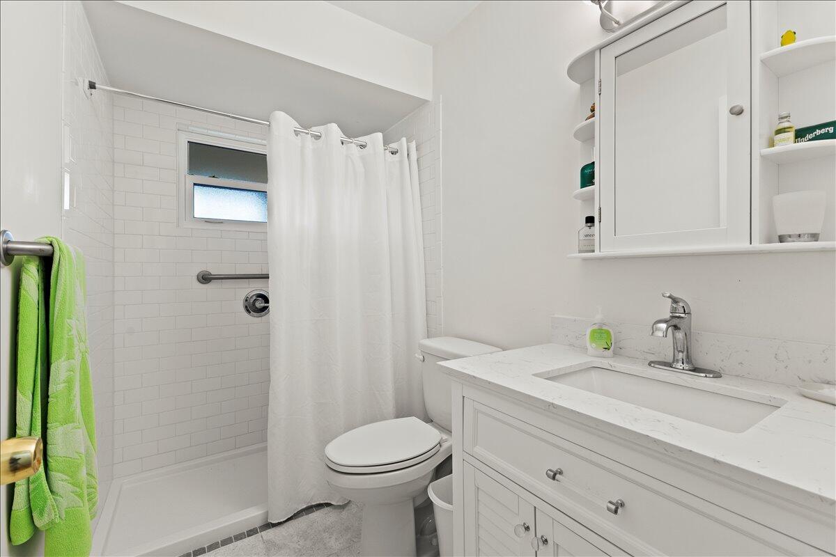 233 Rio Vista Circle Atlantis, FL 33462 - Photo 24 of 38 a bathroom with a sink toilet and shower