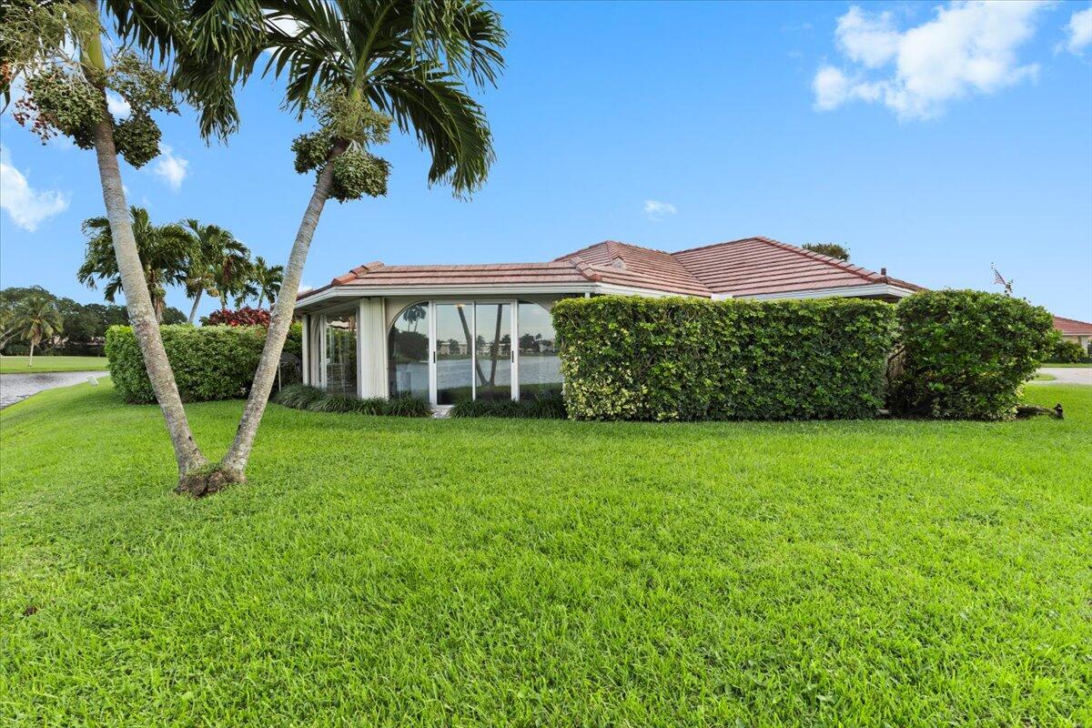 233 Rio Vista Circle Atlantis, FL 33462 - Photo 33 of 38 a front view of a house with a garden