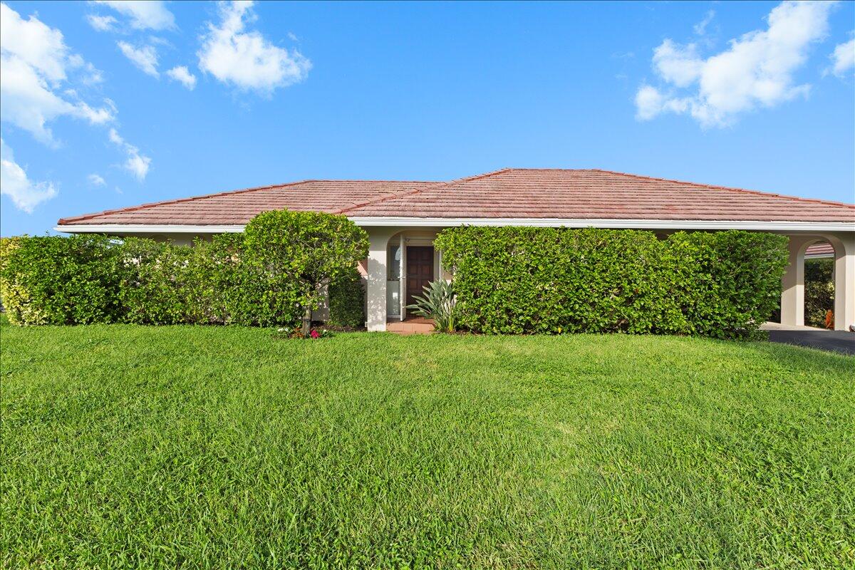 233 Rio Vista Circle Atlantis, FL 33462 - Photo 4 of 38 a view of a house with a garden