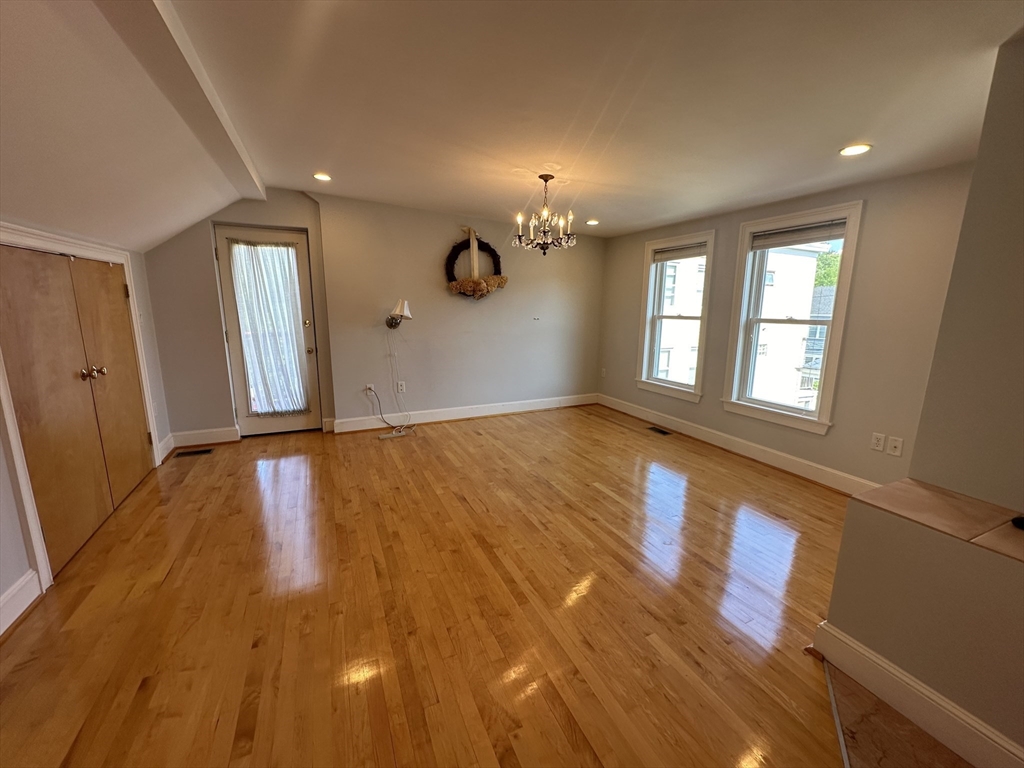17 Herbert Road, Unit 1 Arlington, MA 02474 - Photo 21 of 26 wooden floor in an empty room with a window
