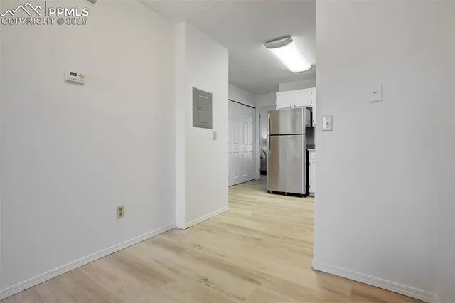 a view of a kitchen with a sink and a refrigerator