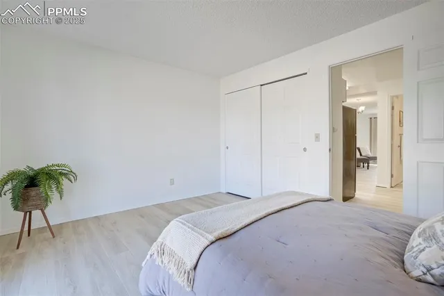 a bedroom with a bed and a potted plant