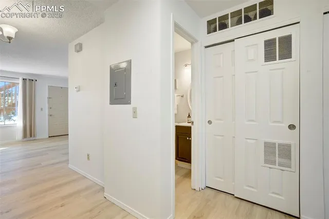 a view of a hallway with wooden floor and entryway