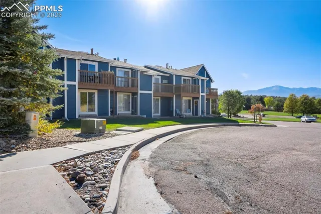 a view of a house with a swimming pool and a yard
