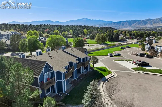 an aerial view of a houses with a yard and lake view