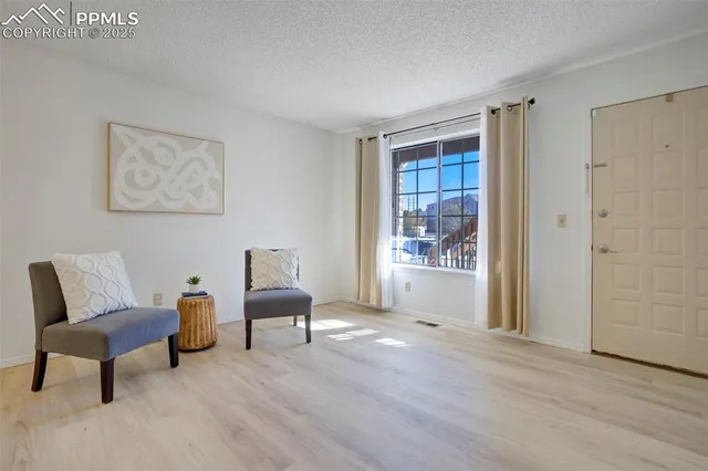 a living room with furniture and a chair