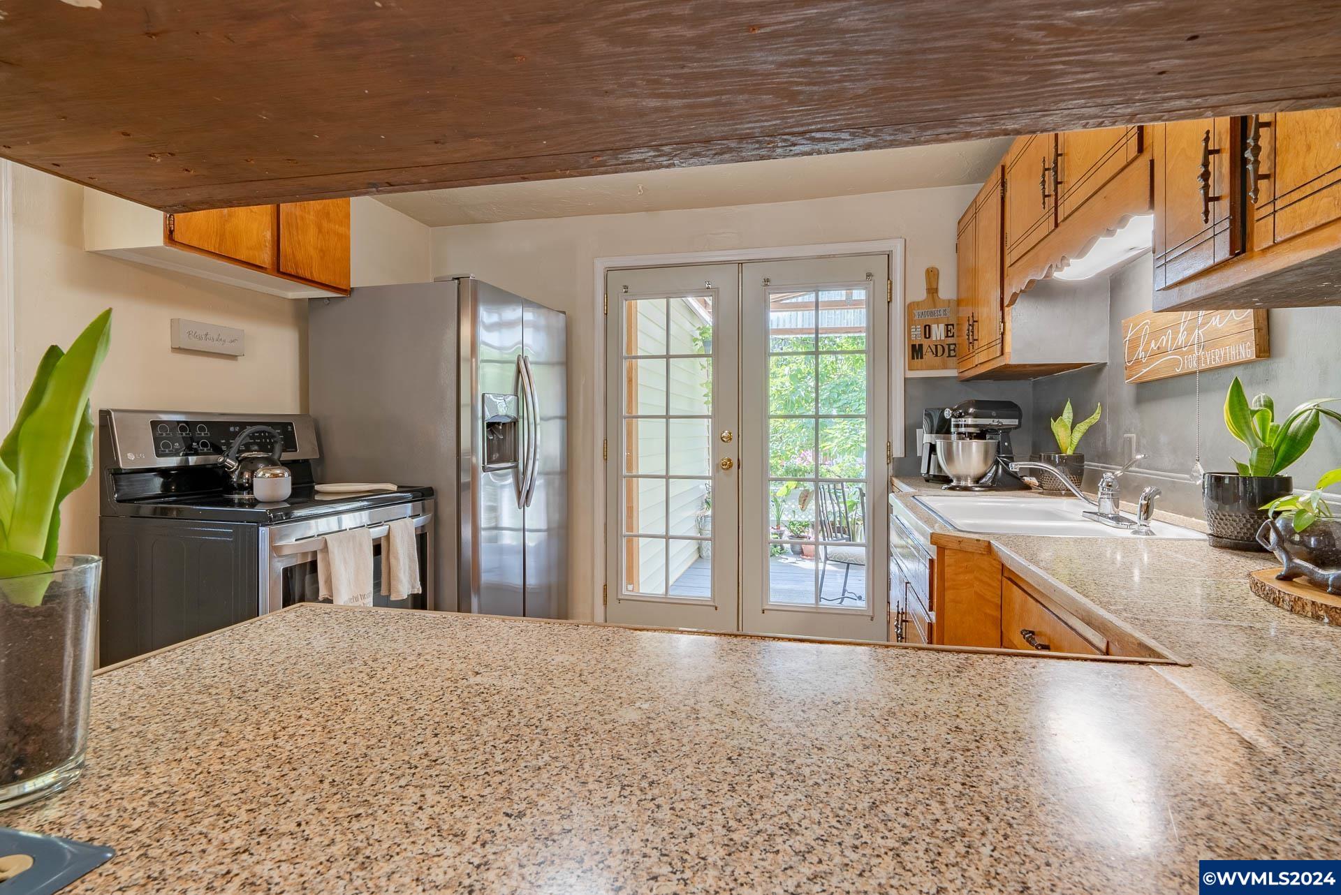 1530 2nd Avenue Albany, OR 97321 - Photo 12 of 35 a kitchen with stainless steel appliances granite countertop a stove and a refrigerator