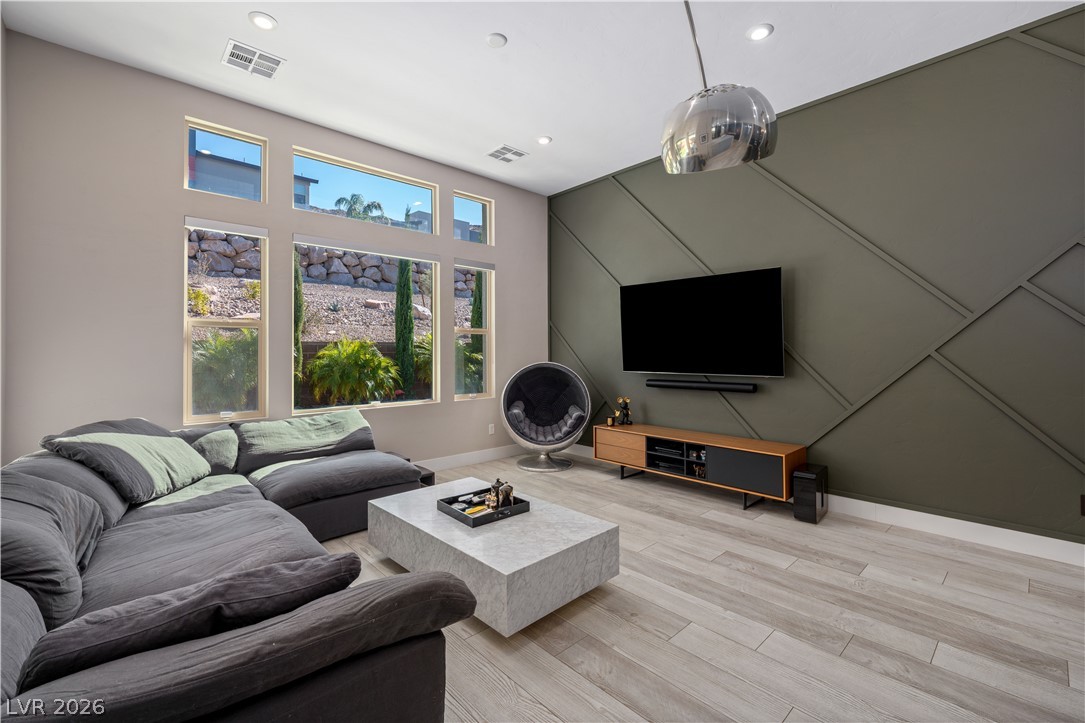 9719 Starlight Ridge Avenue Las Vegas, NV 89148 - Photo 9 of 25 Floor-to-ceiling windows illuminate this spacious living area with natural light and scenic views.