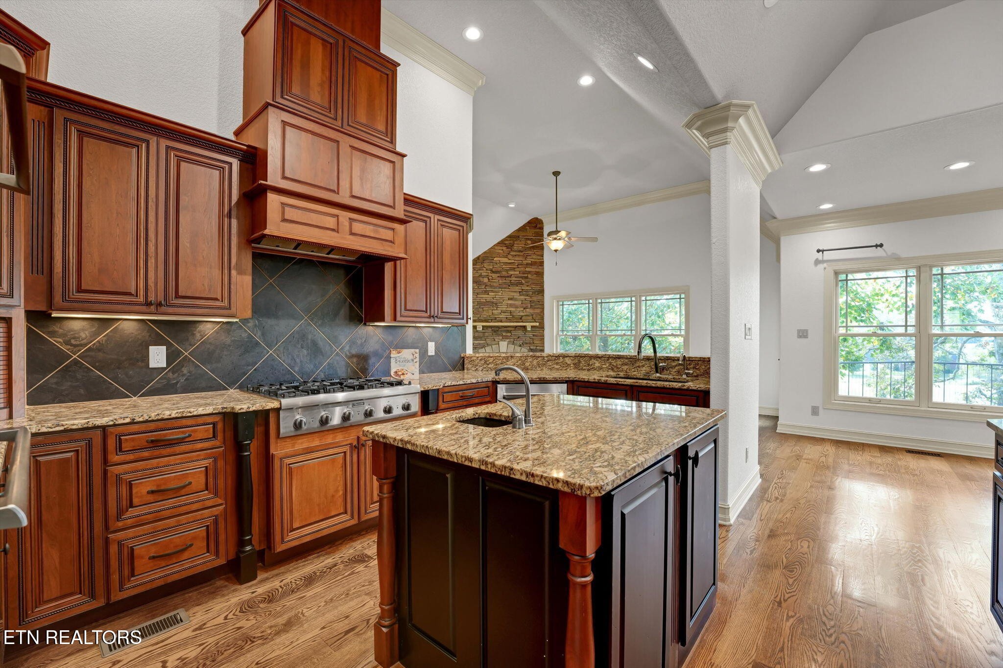 494 Chestnut Lane Loudon, TN 37774 - Photo 15 of 58 a kitchen with granite countertop a stove a sink dishwasher and cabinets with wooden floor