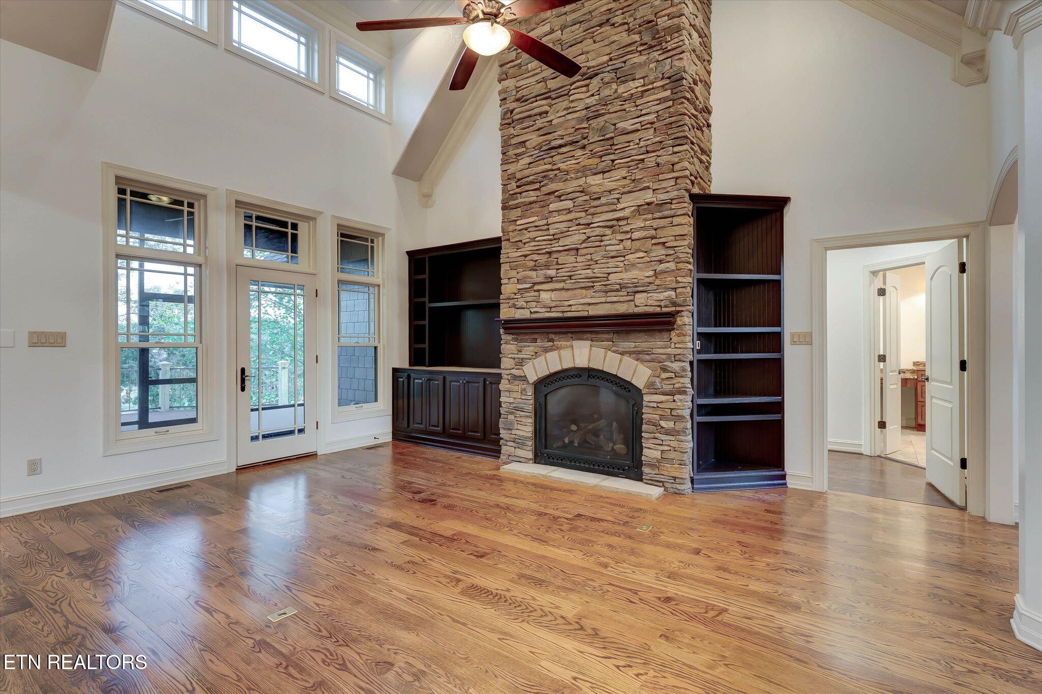 494 Chestnut Lane Loudon, TN 37774 - Photo 9 of 58 an empty room with wooden floor fireplace and windows