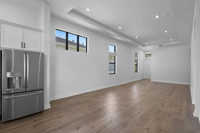 a view of a refrigerator in kitchen and wooden floor