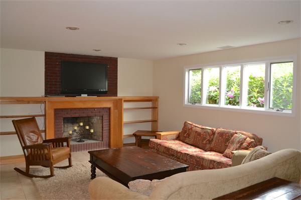 6 Barrett Road Lexington, MA 02421 - Photo 13 of 20 a living room with furniture a flat screen tv and a fireplace