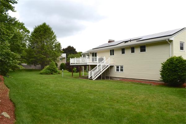 6 Barrett Road Lexington, MA 02421 - Photo 19 of 20 a white house that has a big yard and a wooden fence