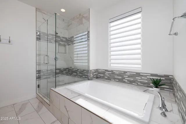 a bath tub sitting next to a shower