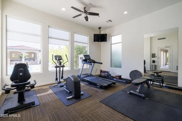 a room with gym equipment and a large window