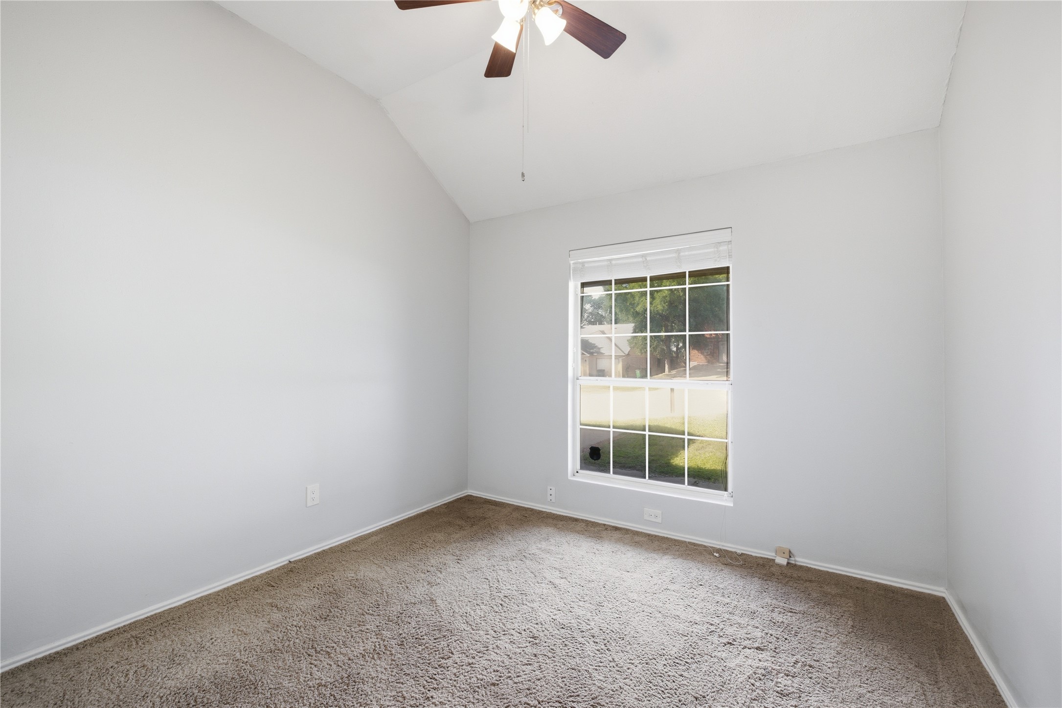 2922 Wickersham Lane Austin, TX 78741 - Photo 7 of 26 an empty room with a window and a fan