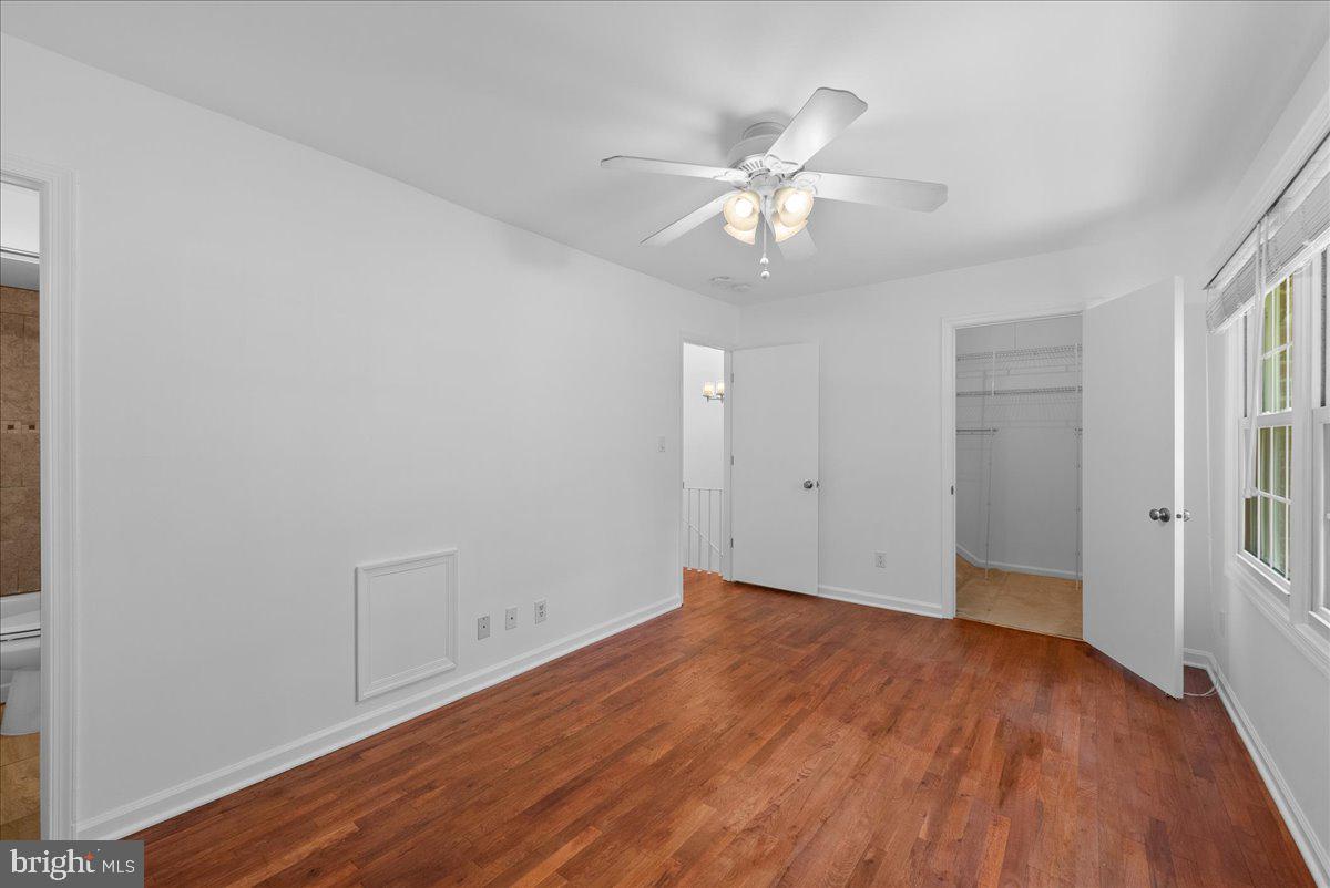 8356 Forrester Boulevard, Unit 470 Springfield, VA 22152 - Photo 25 of 51 an empty room with wooden floor and fan