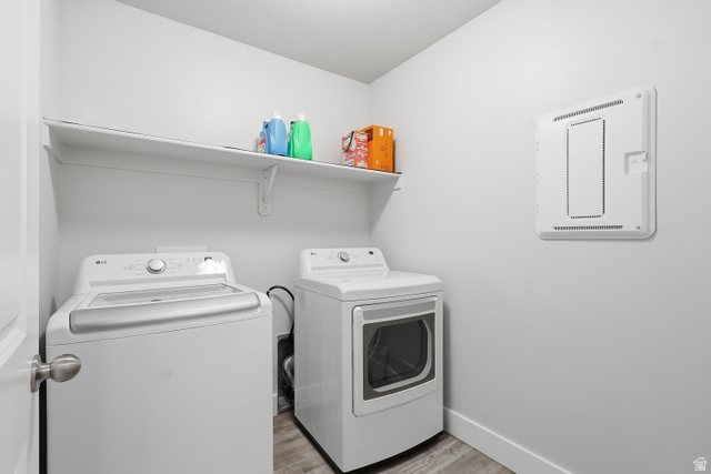 2011 Wren Circle Logan, UT 84339 - Photo 18 of 20 Washroom with light wood-style flooring and washing machine and clothes dryer