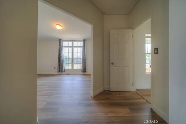 wooden floor in an empty room with a window