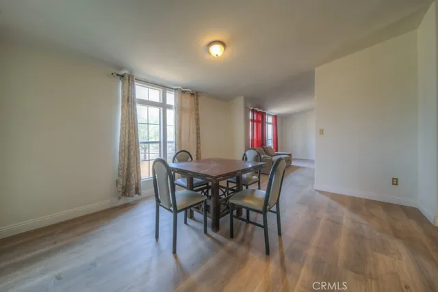 a kitchen with a sink a stove cabinets and a dining table