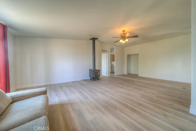 a view of a dry yard with wooden fence
