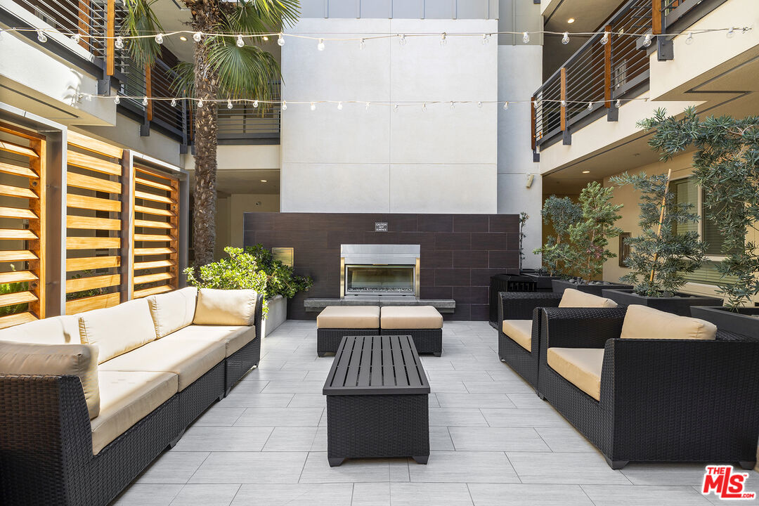 12920 West Runway Road, Unit 222 Playa Vista, CA 90094 - Photo 18 of 23 a outdoor living space with patio furniture and a fireplace