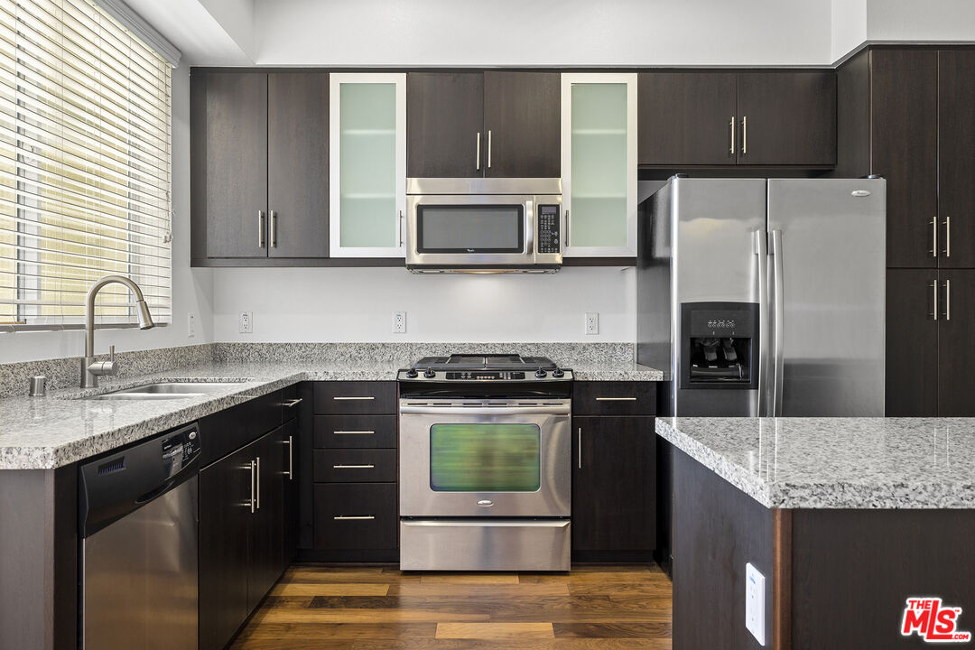 12920 West Runway Road, Unit 222 Playa Vista, CA 90094 - Photo 2 of 23 a kitchen with stainless steel appliances granite countertop a sink stove and refrigerator
