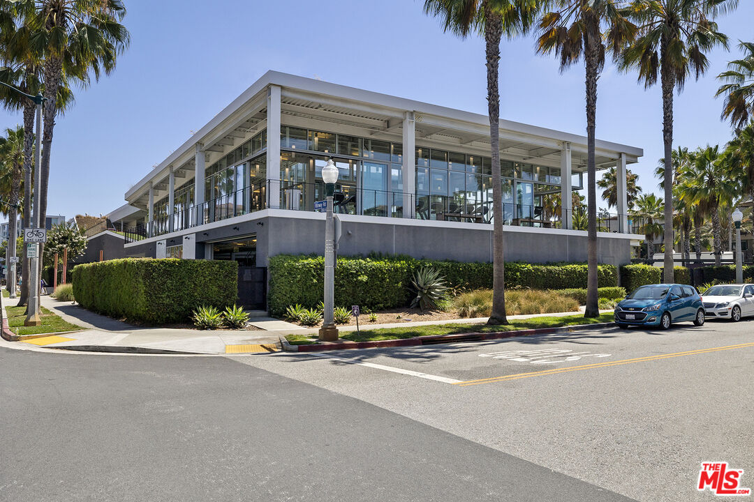 12920 West Runway Road, Unit 222 Playa Vista, CA 90094 - Photo 23 of 23 a view of a street with a building and a palm tree