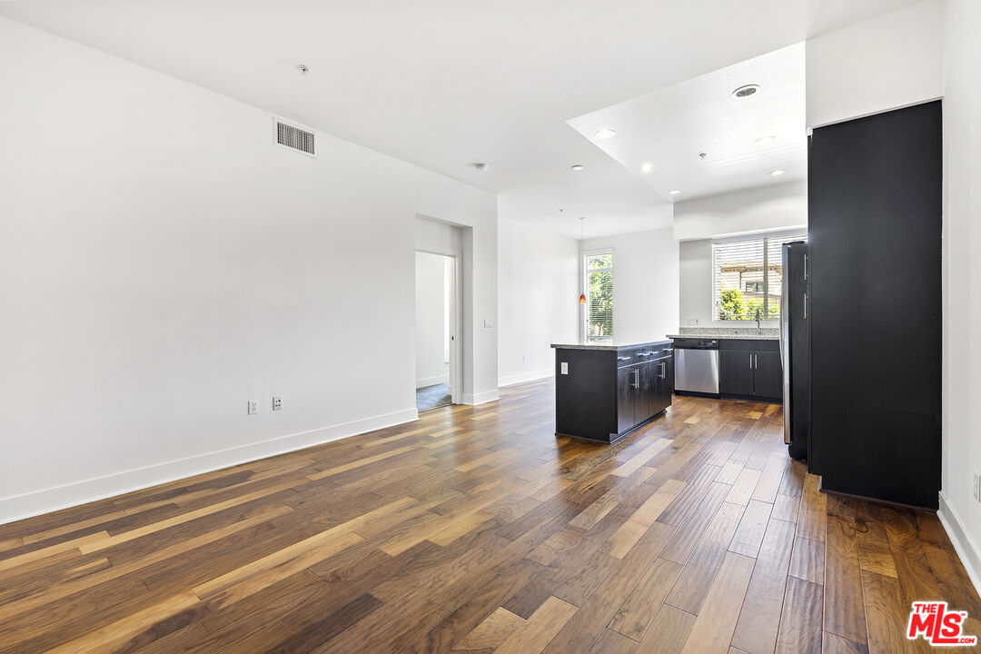 12920 West Runway Road, Unit 222 Playa Vista, CA 90094 - Photo 4 of 23 an empty room with wooden floor and windows