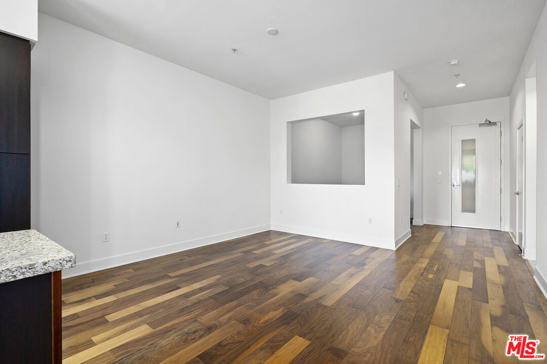 12920 West Runway Road, Unit 222 Playa Vista, CA 90094 - Photo 6 of 23 a view of an empty room with wooden floor