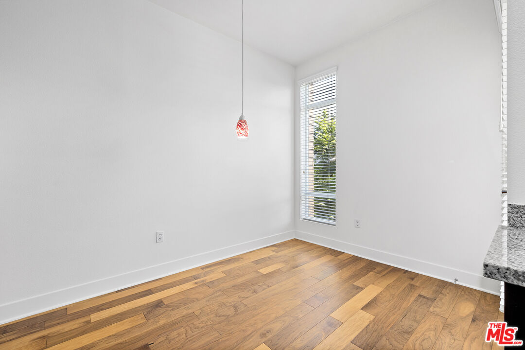 12920 West Runway Road, Unit 222 Playa Vista, CA 90094 - Photo 7 of 23 a view of an empty room with wooden floor and a window