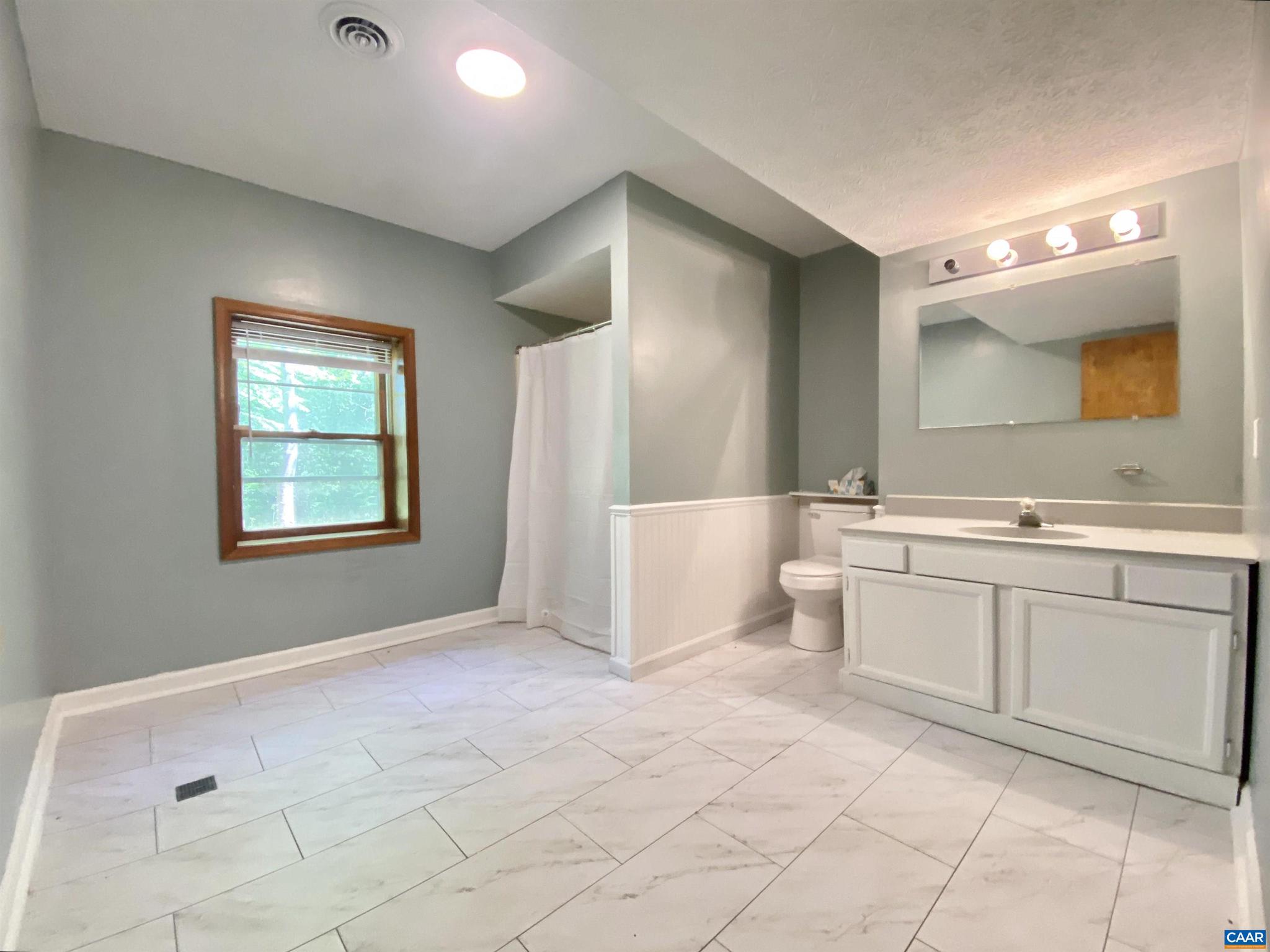 247 Goldenrod Road Ruckersville, VA 22968 - Photo 21 of 35 a spacious bathroom with a double vanity sink and a mirror