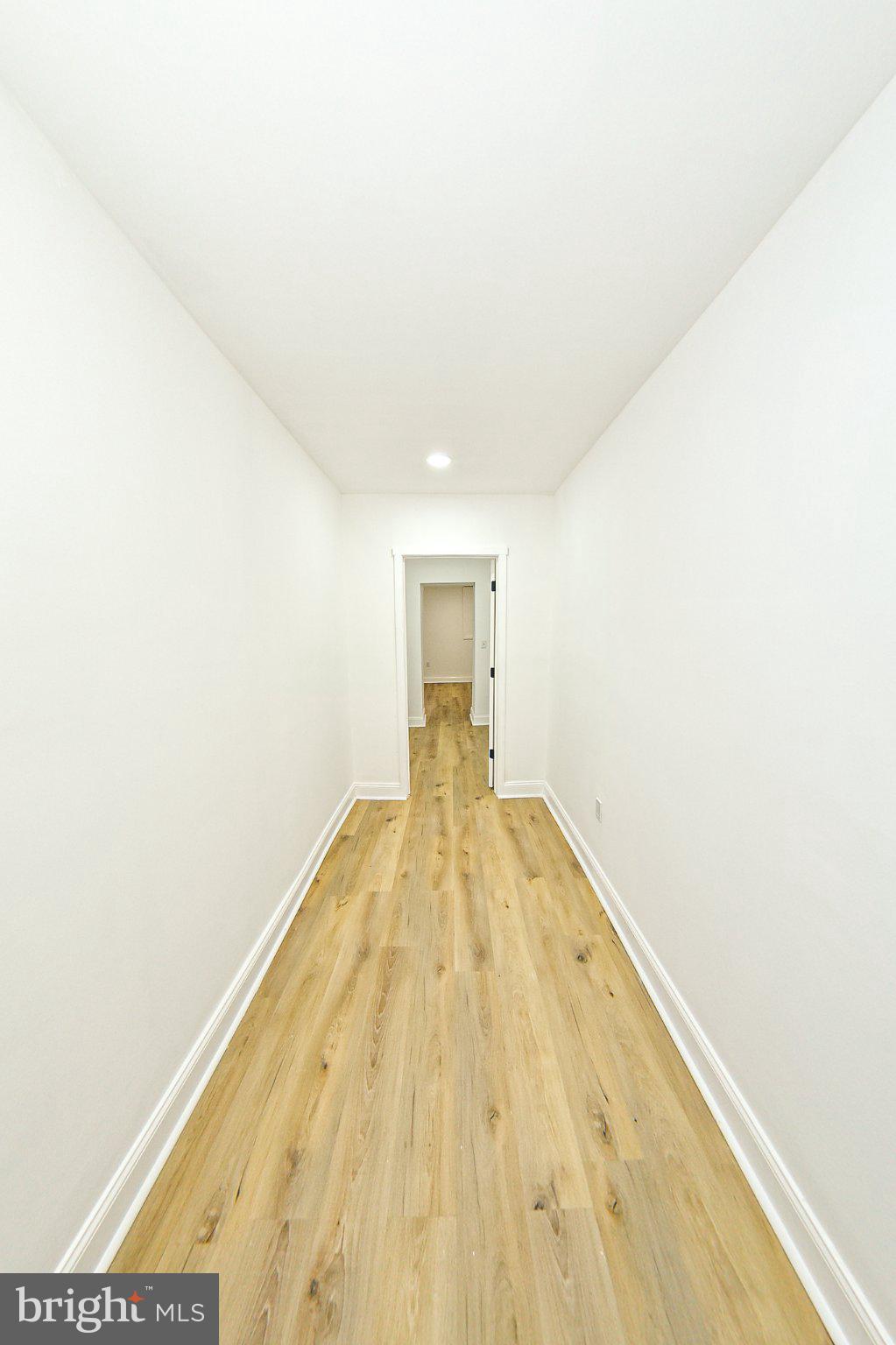 3704 Suitland Road Southeast Washington, DC 20020 - Photo 33 of 70 a view of a big room with wooden floor and a ceiling fan