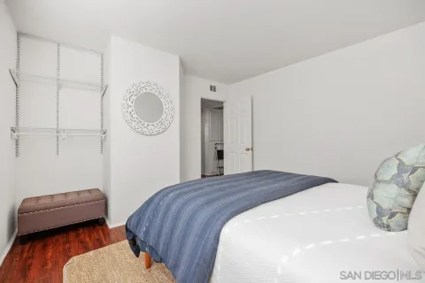 a bedroom with a bed a couch and a closet