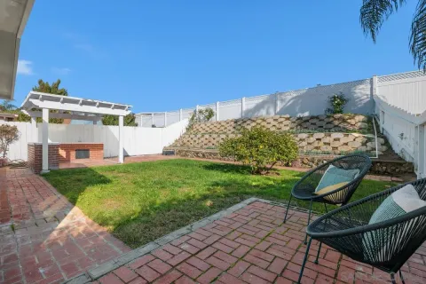 a view of a chairs and table in backyard