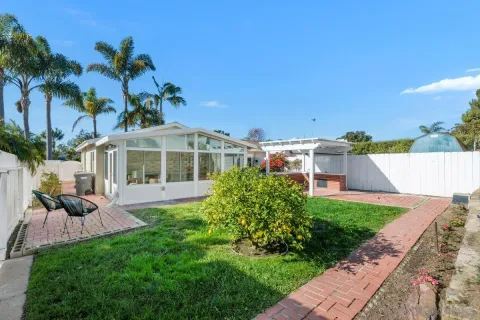 a front view of a house with a garden and yard