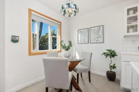 a dining room with furniture and front door