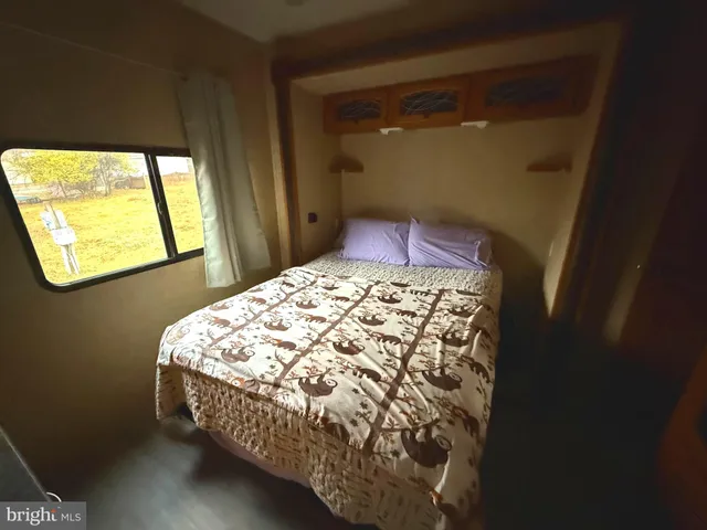 a bed sitting in a bedroom next to a window