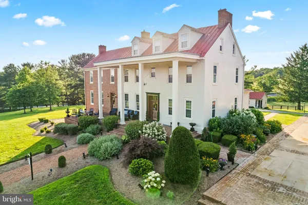 an aerial view of a houses with swimming pool