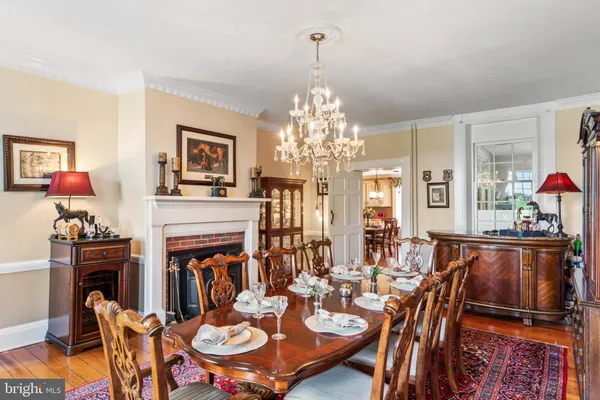 a view of a dining room with furniture and chandelier
