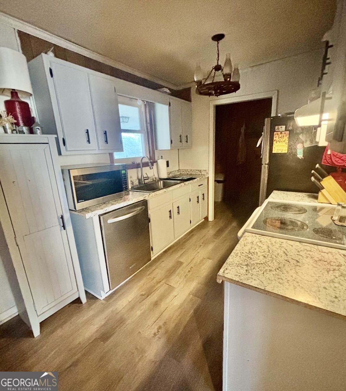 74 Hanshaw Drive Rock Spring, GA 30739 - Photo 2 of 13 a kitchen with granite countertop a sink stove and refrigerator