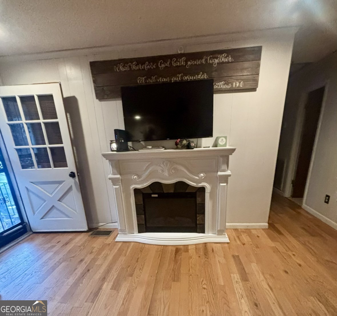 74 Hanshaw Drive Rock Spring, GA 30739 - Photo 5 of 13 a living room with a fireplace and a flat screen tv
